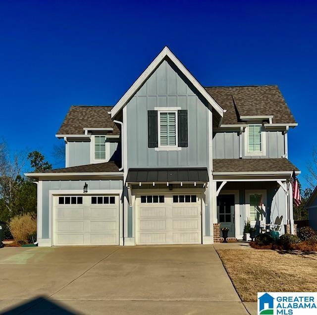 view of front facade featuring driveway, a garage, and board and batten siding