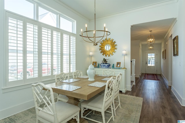 dining space featuring crown molding, dark wood-style flooring, baseboards, and a notable chandelier