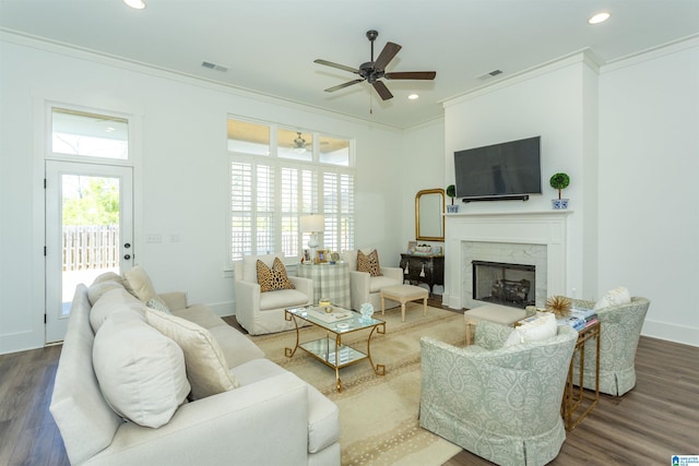 living area featuring ornamental molding, wood finished floors, visible vents, and recessed lighting