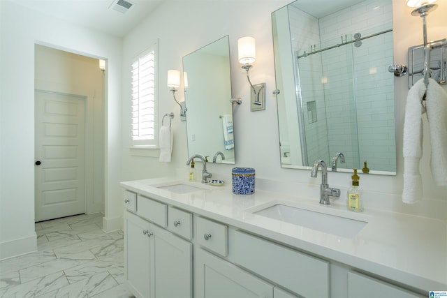 full bath with marble finish floor, a shower stall, visible vents, and a sink