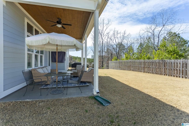 view of patio featuring a ceiling fan, a fenced backyard, and an outdoor living space