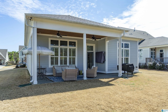 rear view of house featuring an outdoor living space, a lawn, a patio area, and a ceiling fan