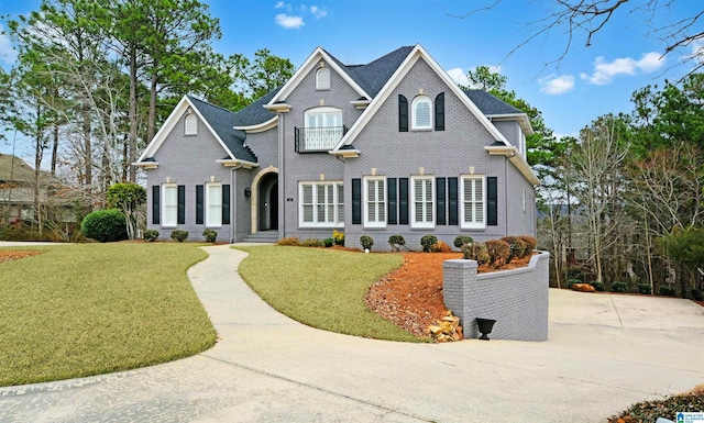 view of front of property with a front yard and brick siding