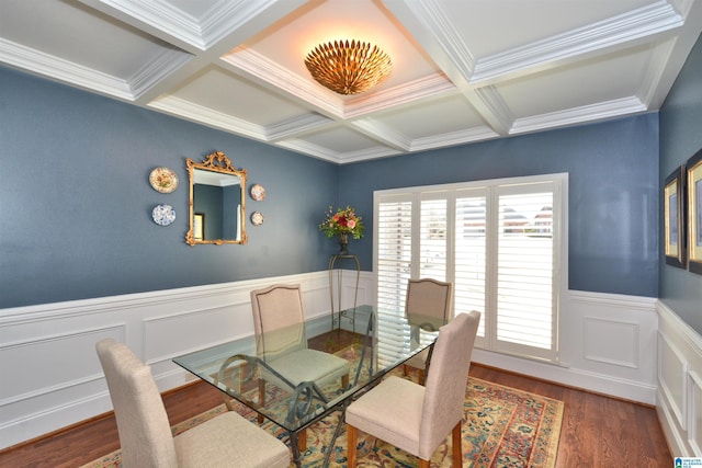 dining area with coffered ceiling, a wainscoted wall, ornamental molding, wood finished floors, and beam ceiling