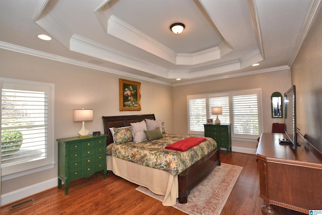 bedroom featuring visible vents, a tray ceiling, dark wood finished floors, and baseboards