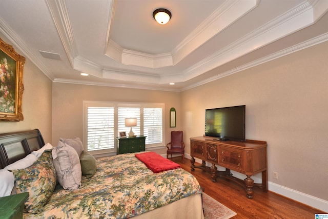 bedroom featuring baseboards, a tray ceiling, dark wood-type flooring, and ornamental molding