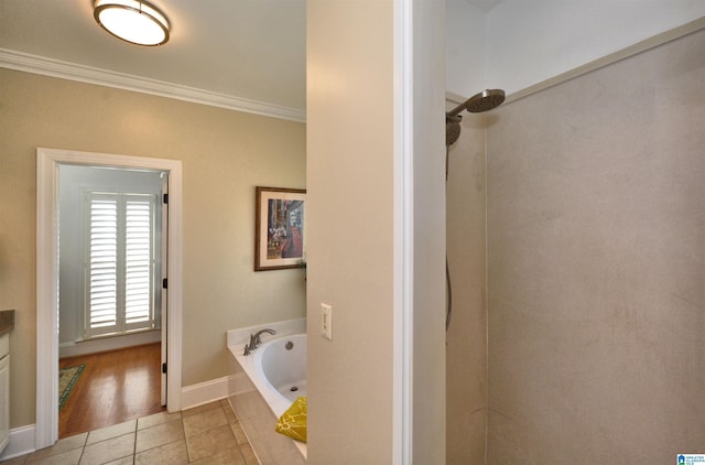 bathroom with baseboards, a shower, ornamental molding, tile patterned floors, and a bath