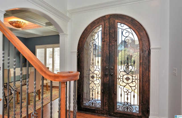 foyer with coffered ceiling, wood finished floors, stairs, french doors, and ornamental molding