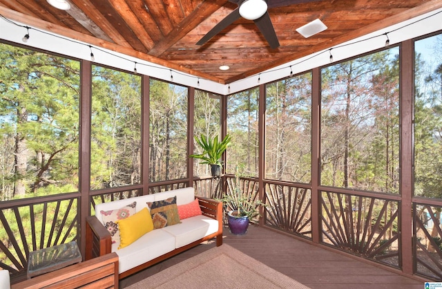 unfurnished sunroom featuring a wealth of natural light, wood ceiling, and ceiling fan