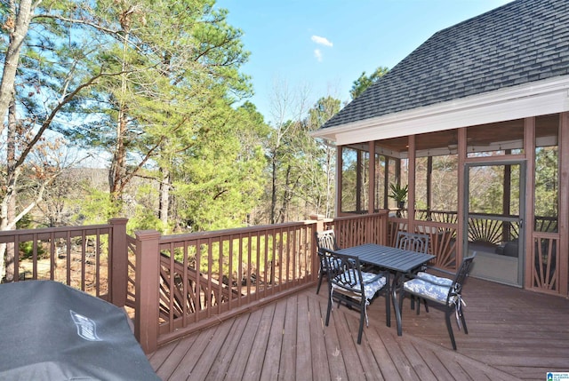 deck with outdoor dining space and area for grilling