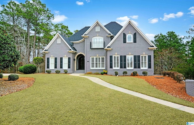 view of front of house with brick siding and a front yard