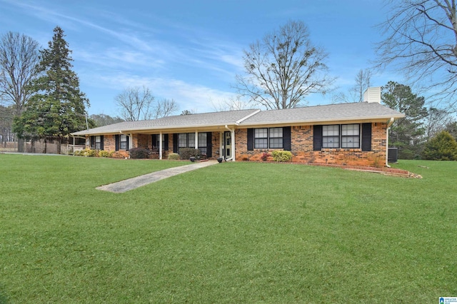 ranch-style home featuring central AC, brick siding, roof with shingles, a front lawn, and a chimney