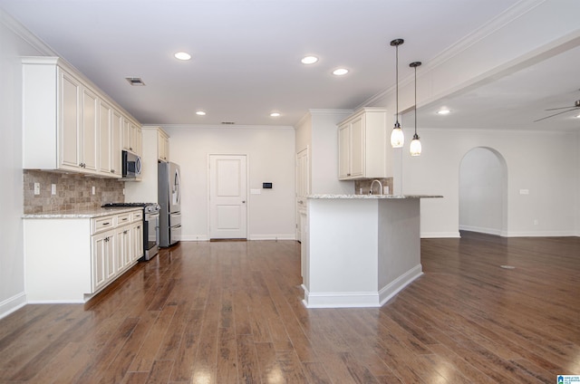 kitchen with arched walkways, white cabinets, hanging light fixtures, light stone countertops, and stainless steel appliances