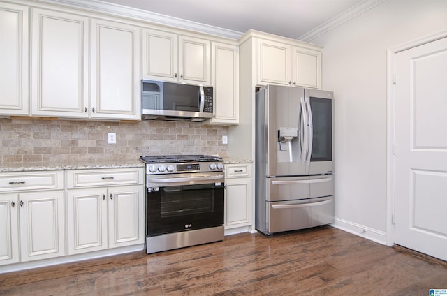 kitchen featuring tasteful backsplash, dark wood-style floors, light stone counters, ornamental molding, and stainless steel appliances