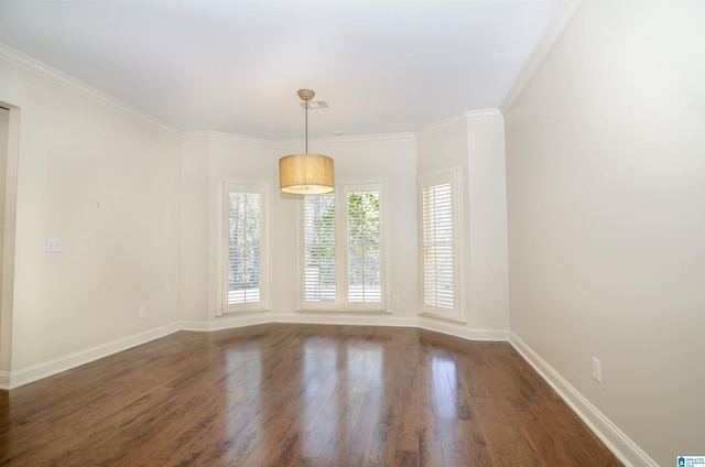 unfurnished room featuring ornamental molding, dark wood finished floors, and baseboards