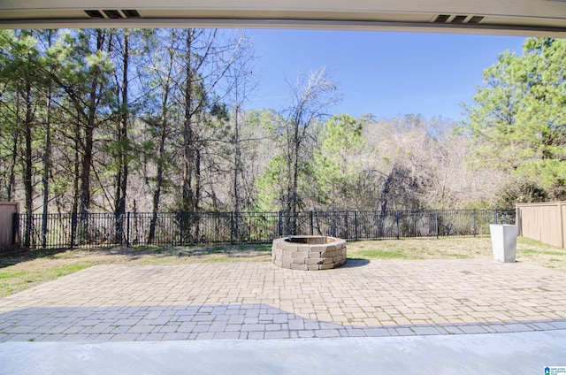 view of patio / terrace with an outdoor fire pit and a fenced backyard