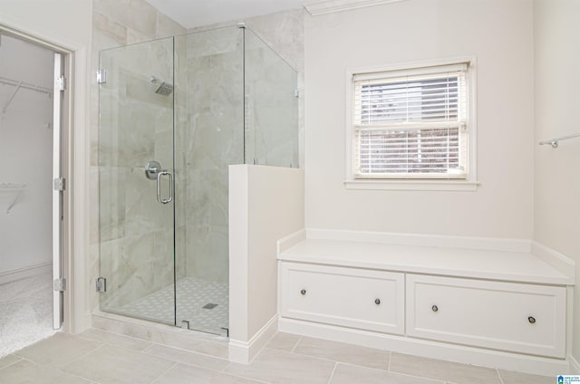 full bath with a stall shower, tile patterned flooring, and a walk in closet