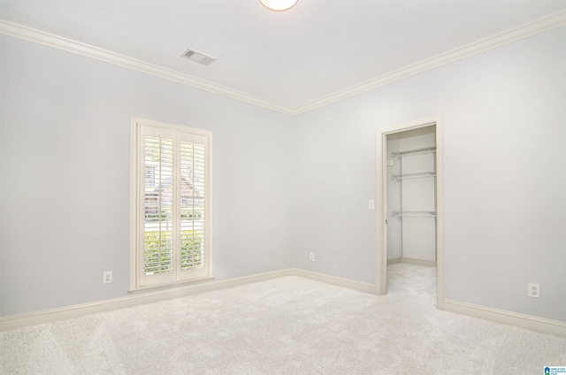 empty room featuring visible vents, crown molding, light carpet, and baseboards