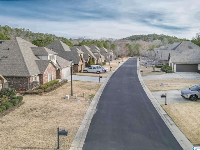 view of street featuring a residential view and curbs