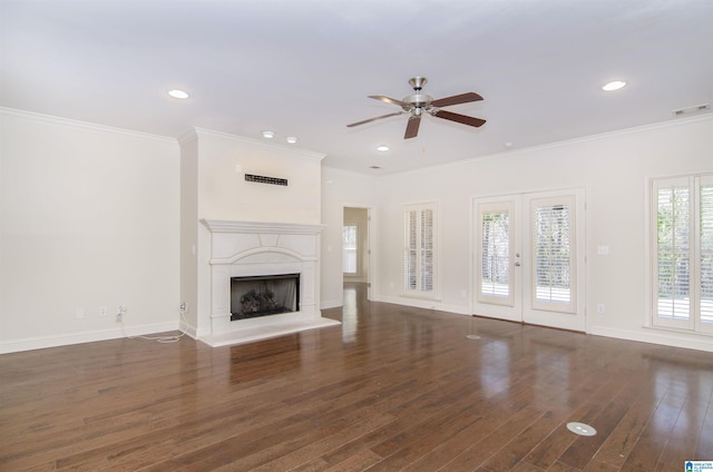 unfurnished living room featuring a fireplace with raised hearth, dark wood-style flooring, visible vents, baseboards, and french doors