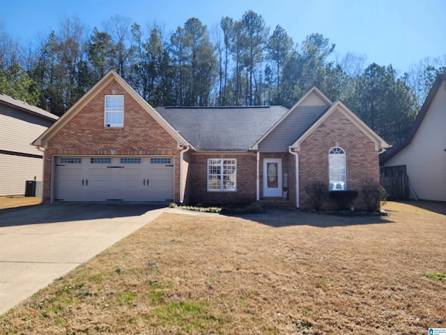 view of front of property featuring a garage, driveway, brick siding, and a front lawn