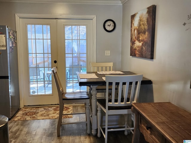 dining space featuring ornamental molding, a wealth of natural light, french doors, and wood finished floors