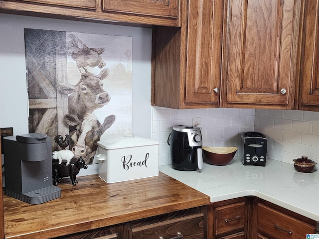 kitchen featuring butcher block counters and backsplash