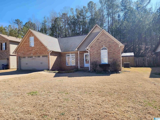 ranch-style house featuring brick siding, central air condition unit, fence, a garage, and driveway