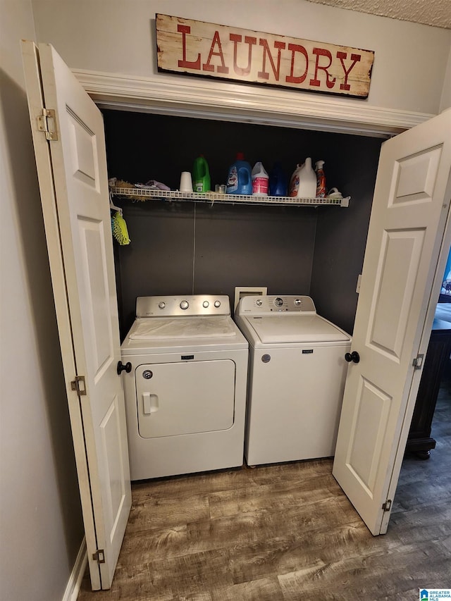 washroom with laundry area, dark wood-type flooring, and washer and dryer