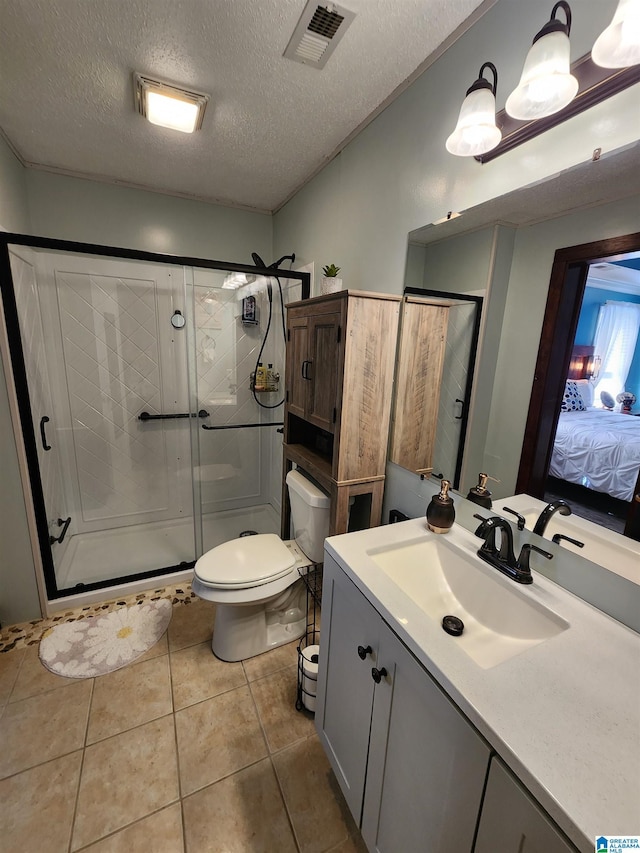 ensuite bathroom featuring connected bathroom, toilet, visible vents, a shower stall, and tile patterned floors