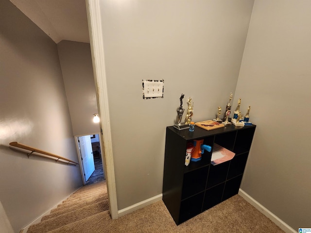 interior space with lofted ceiling, carpet, and baseboards