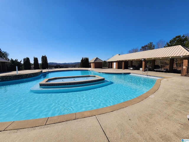 pool with a community hot tub, a patio, and a gazebo