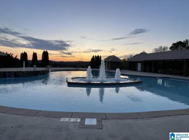 view of pool at dusk