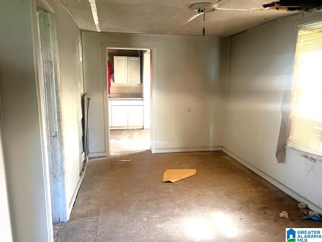 spare room with unfinished concrete floors