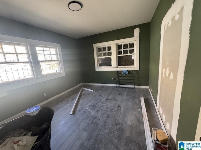 interior space with dark wood-style flooring and baseboards