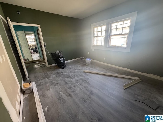 unfurnished bedroom featuring dark wood-type flooring and baseboards