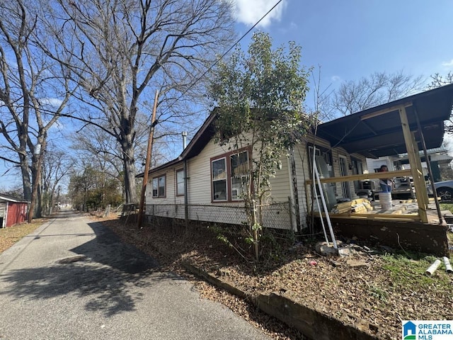 view of home's exterior with aphalt driveway