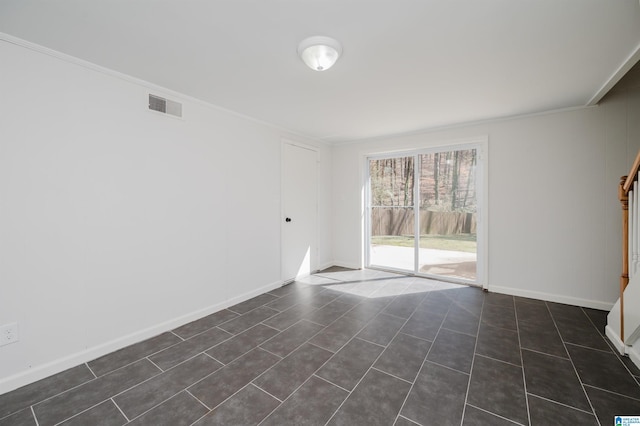 unfurnished room featuring ornamental molding, visible vents, and baseboards