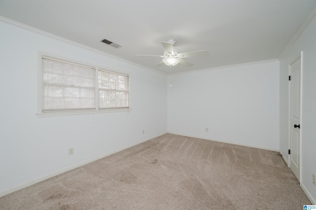 unfurnished room with a ceiling fan, visible vents, crown molding, and light colored carpet