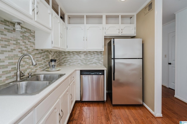 kitchen with a sink, visible vents, light countertops, appliances with stainless steel finishes, and open shelves