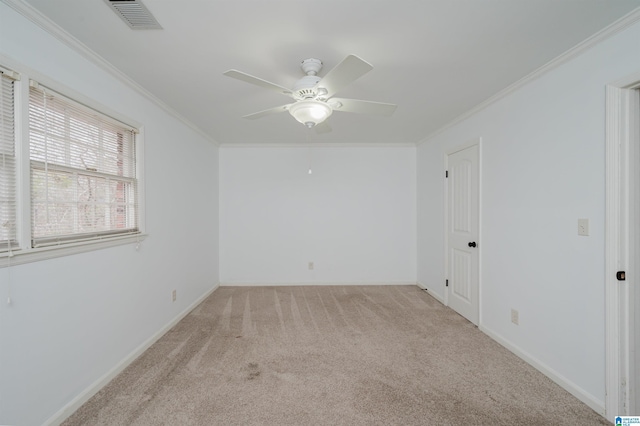 unfurnished room with visible vents, a ceiling fan, light colored carpet, and crown molding