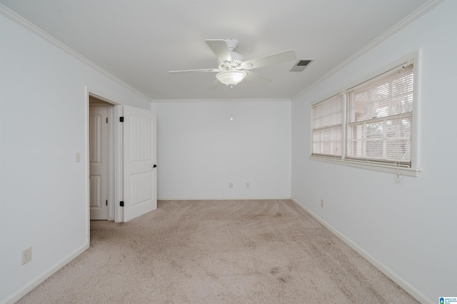 unfurnished room featuring ornamental molding, light carpet, ceiling fan, and visible vents