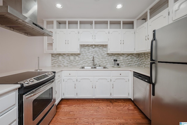 kitchen featuring stainless steel appliances, light countertops, white cabinets, a sink, and extractor fan