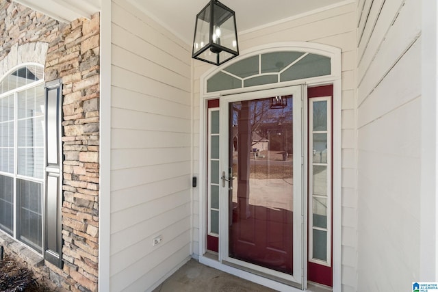 property entrance featuring brick siding