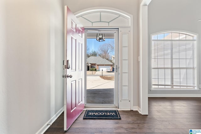 entryway featuring dark wood finished floors and baseboards