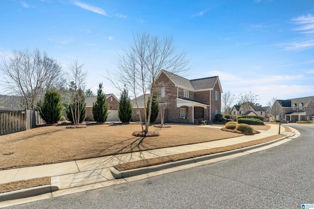 view of front of property with a residential view, brick siding, and fence