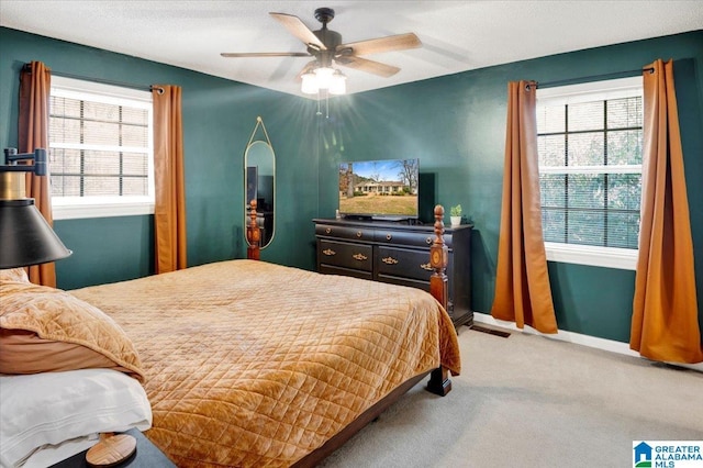 bedroom featuring carpet floors, baseboards, and a ceiling fan