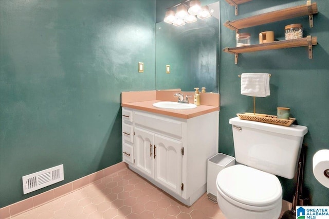 bathroom featuring toilet, tile patterned floors, visible vents, and vanity