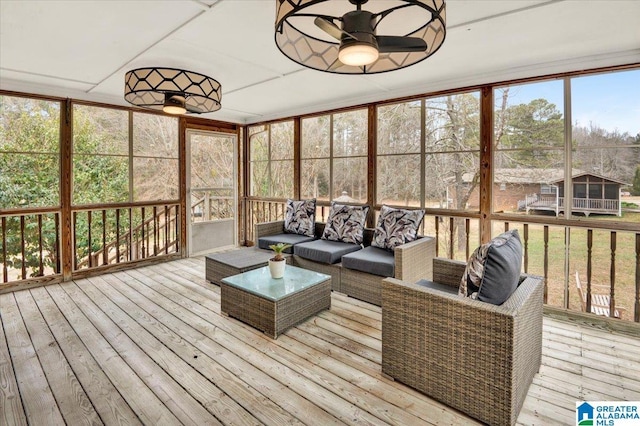 sunroom / solarium featuring ceiling fan