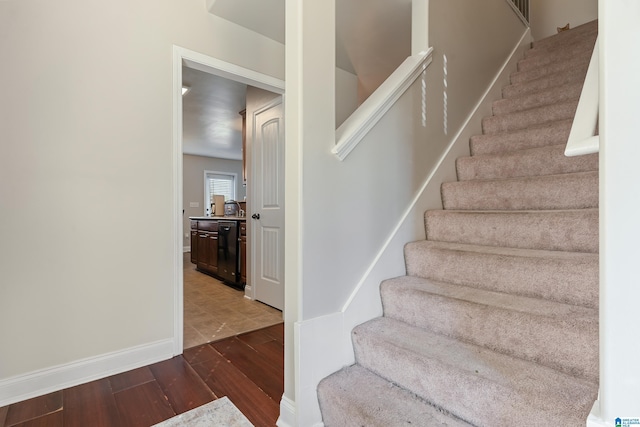 stairs with baseboards and wood finished floors